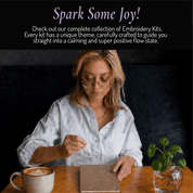 Woman doing paper embroidery with Unwynd beginner embroidery kit – easy hand embroidery notebook kit for adults as a mindful hobby