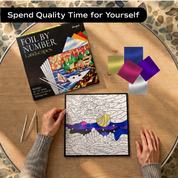 Woman doing Unwynd Foil by Number Landscapes foil art kit – quality time creative hobby for adults with metallic foil sheets and landscape board