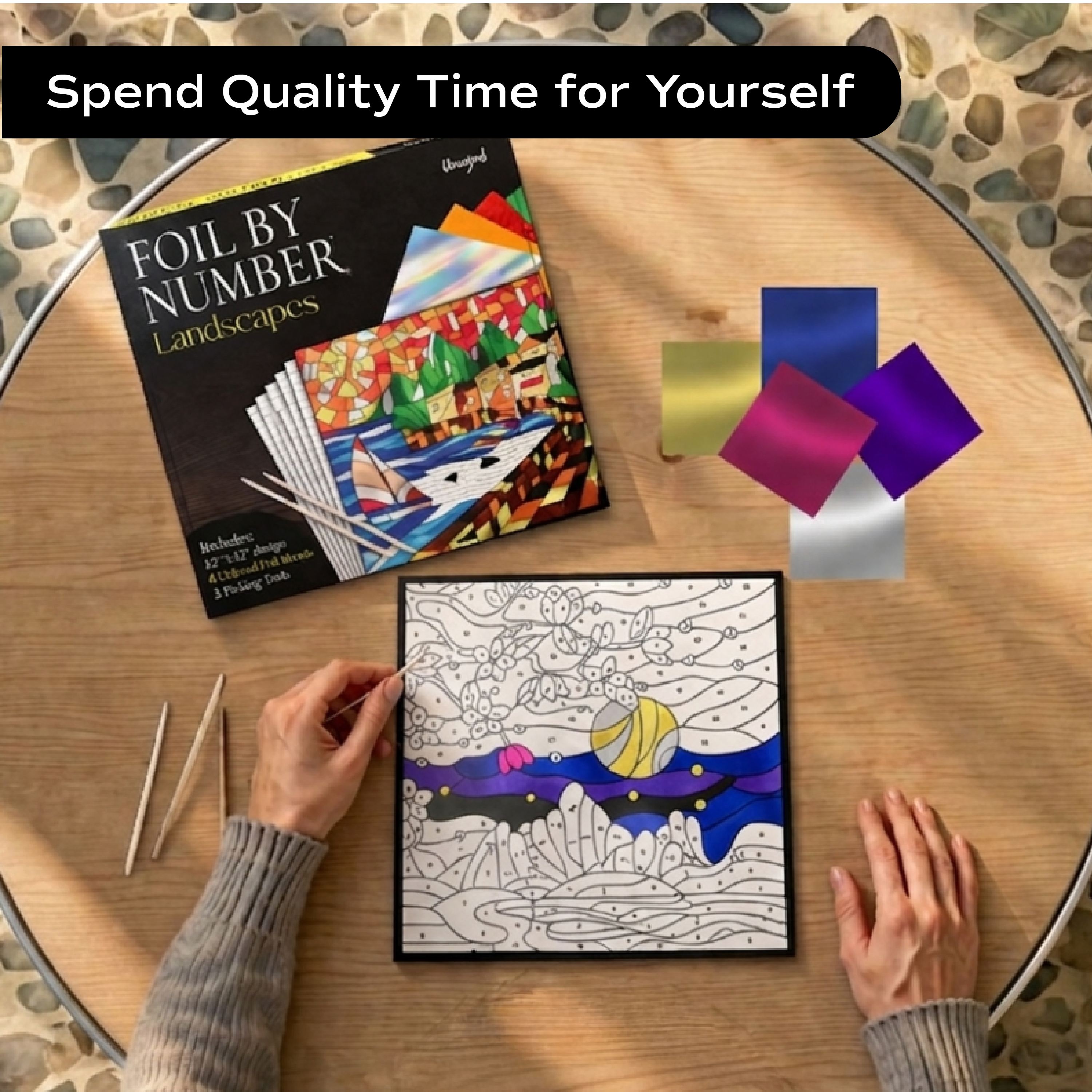 Woman doing Unwynd Foil by Number Landscapes foil art kit – quality time creative hobby for adults with metallic foil sheets and landscape board